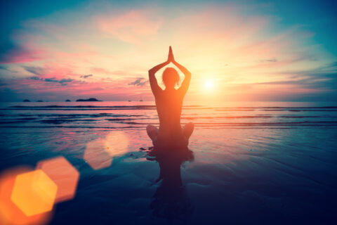 Silhouette,Young,Woman,Practicing,Yoga,On,The,Beach,At,Sunset.